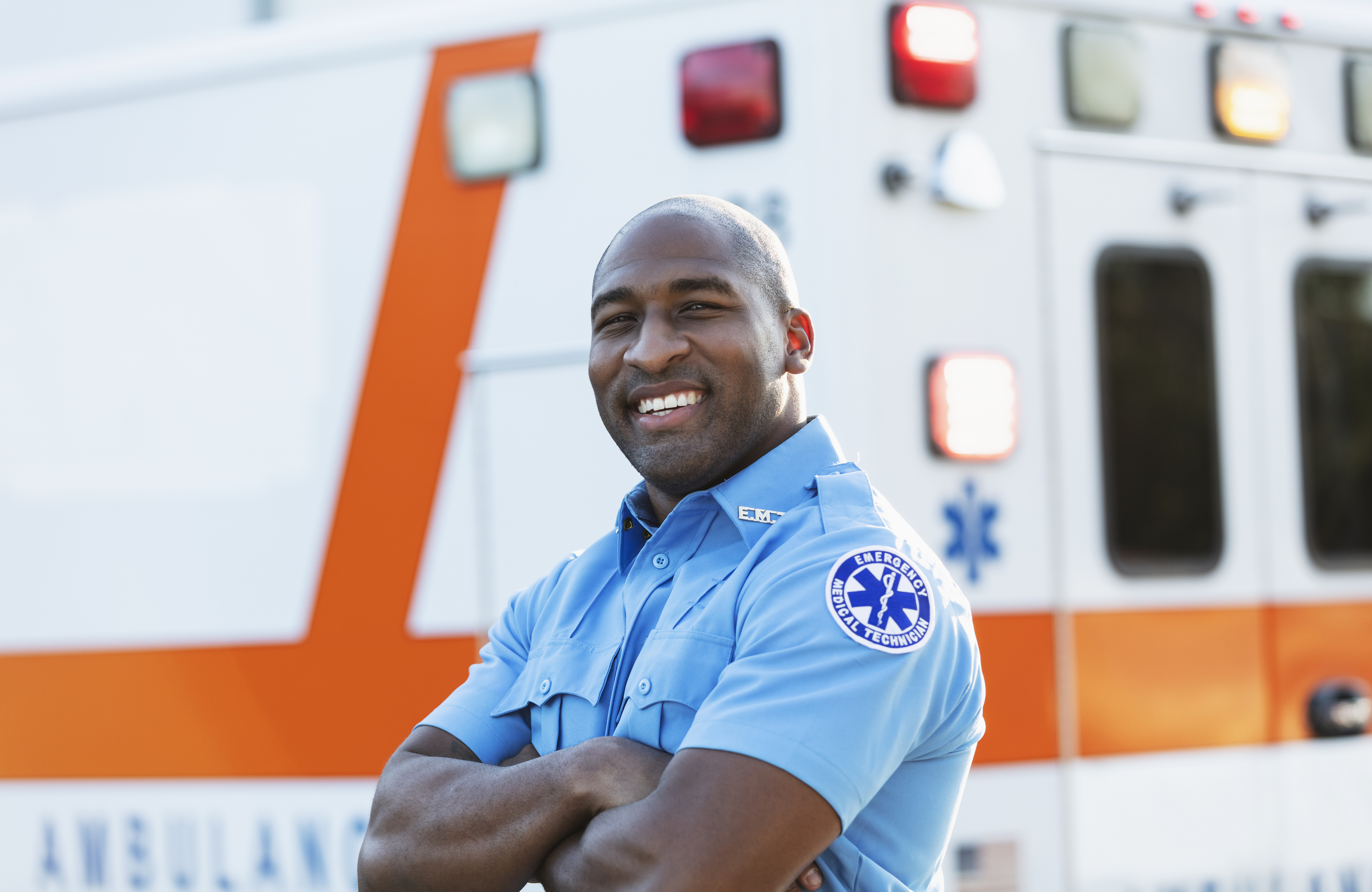EMT professional in front of ambulance
